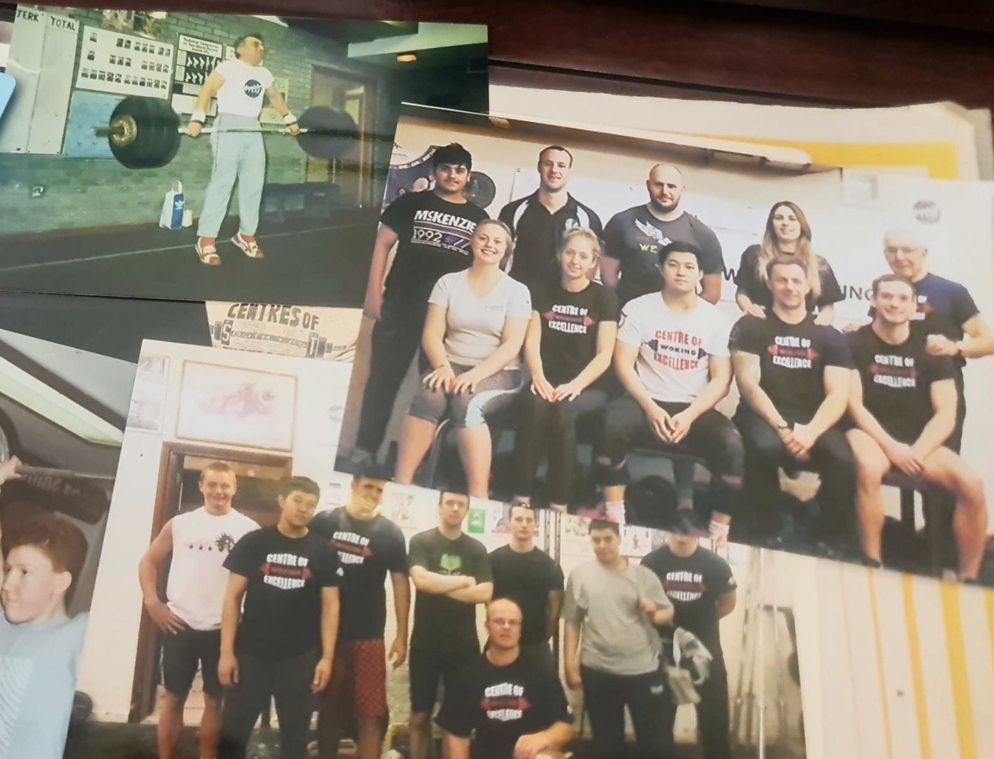 Printed club photos laid out together, including two Centre of Excellence team groups